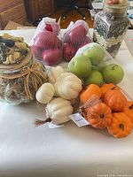 Group shot of all items: two glass jars and four mesh bags of faux produce