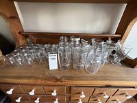 Group shot of all glass items on wooden dresser