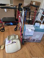 Group shot showing rollator, folding walker, boxed shower chair, OxyFlow device, cane