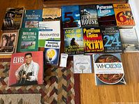 All 16 books laid out on floor showing titles and covers