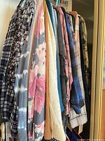 Row of hanging long-sleeve shirts showing patterns and fabrics