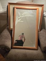 Front view of etched mirror with two framed prints behind