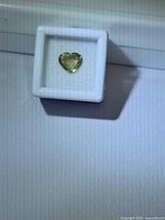 Heart cut mossy green sapphire in display box