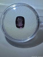 Spinel in display case showing overall shape and color