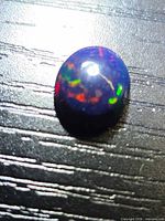 Top view of the opal displaying multicolored flashes