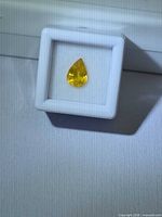 Front view of pear-cut yellow sapphire in display box