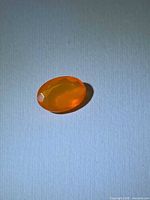 Top view of oval orange Mexican fire opal