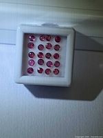 Front view of gem box showing 20 round rubies