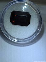 Rectangular step-cut tourmaline in gem jar angled view