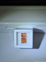 Front view of nine square padparadcha sapphires in white gem box