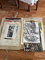 Open portfolio showing stacked assorted artworks