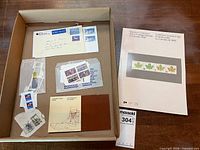 Open box showing envelope, plastic sleeves with stamps, Flying Boats pack, Souvenir Collection booklet