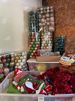 Overview of lot showing ornament packages, tote with garland and stockings