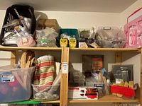 Overall view of shelves holding bins with assorted craft supplies