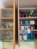 Cabinet overview showing mugs, stemware, blue tumblers and part of water bottle collection