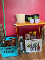 Overall lot on metal shelf with pots, crate, tools visible
