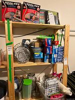 Overview of wooden shelving unit with all household items