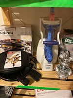 Boxed Trudeau grill set, Arctic Twister unit, LEM grinder box and parts on shelf