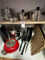 Overall view of cookware, pans, baking sheets and utensils on shelves