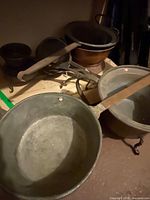 Overview showing multiple metal pots and utensils