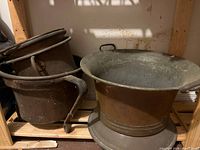 Group showing three metal containers on shelf
