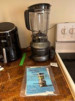 Full view of blender with pitcher and manuals