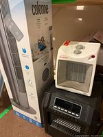 Seville Classics tower fan box, Sunbeam heater, Classic infrared heater grouped