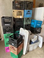 Stack of multicolored milk crates next to storage totes