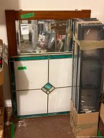Stained glass panel, mirror, packaged LERBERG shelves leaning together