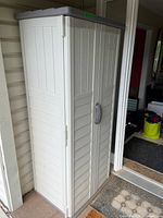 Full exterior view of Suncast resin vertical shed closed
