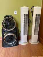 Front view showing two tower fans beside dual fan unit