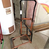 Full-height orange and black upright hand truck