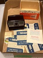Viewer, box, reel sleeves, instruction leaflet inside open carton