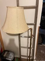 Full view of lamp with shade and ladder behind