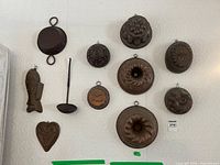 Wall display showing full grouping of moulds, pan and utensil