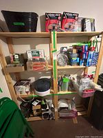 Full view of pine shelving unit loaded with various excluded items