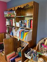 full view of wooden shelving unit with shelves and lower cabinet doors