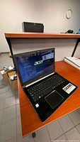 Open Acer Aspire 5 A515 laptop on desk, screen powered on