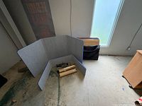 Full view of folded gray felt panel, lights, tubes, carry bag visible