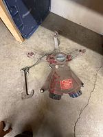 Full view of ground monitor base with attached chains, hook visible