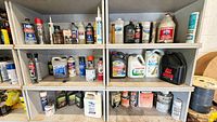 Full view of shelving with assorted fluids, paints and aerosols