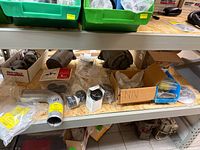 Front shelf with alternator, metal elbow, boxes and bagged parts