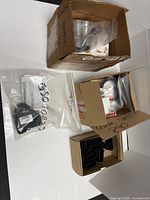 Multiple boxes and bags containing assorted hardware items