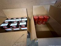Open cartons showing eight boxed B1441 and three loose red BT7349 Baldwin oil filters