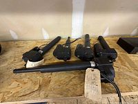 Five black Bear Linear actuators laid out on bench