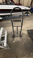Full front view of black steel hand truck showing loop handle, frame and wheels