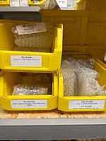 Overview of yellow bins containing bubble-wrapped Code 3 bulbs; visible labels PS-T01549, PS-T01540, PS-T07008, PS-S81342