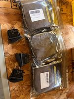Three sealed eFuncar switch packs and four loose rocker switches on work surface