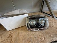 Front view of Federal Signal GHSCENE light beside original plain white box
