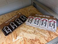 Two packaged wooden sign sets on shelf